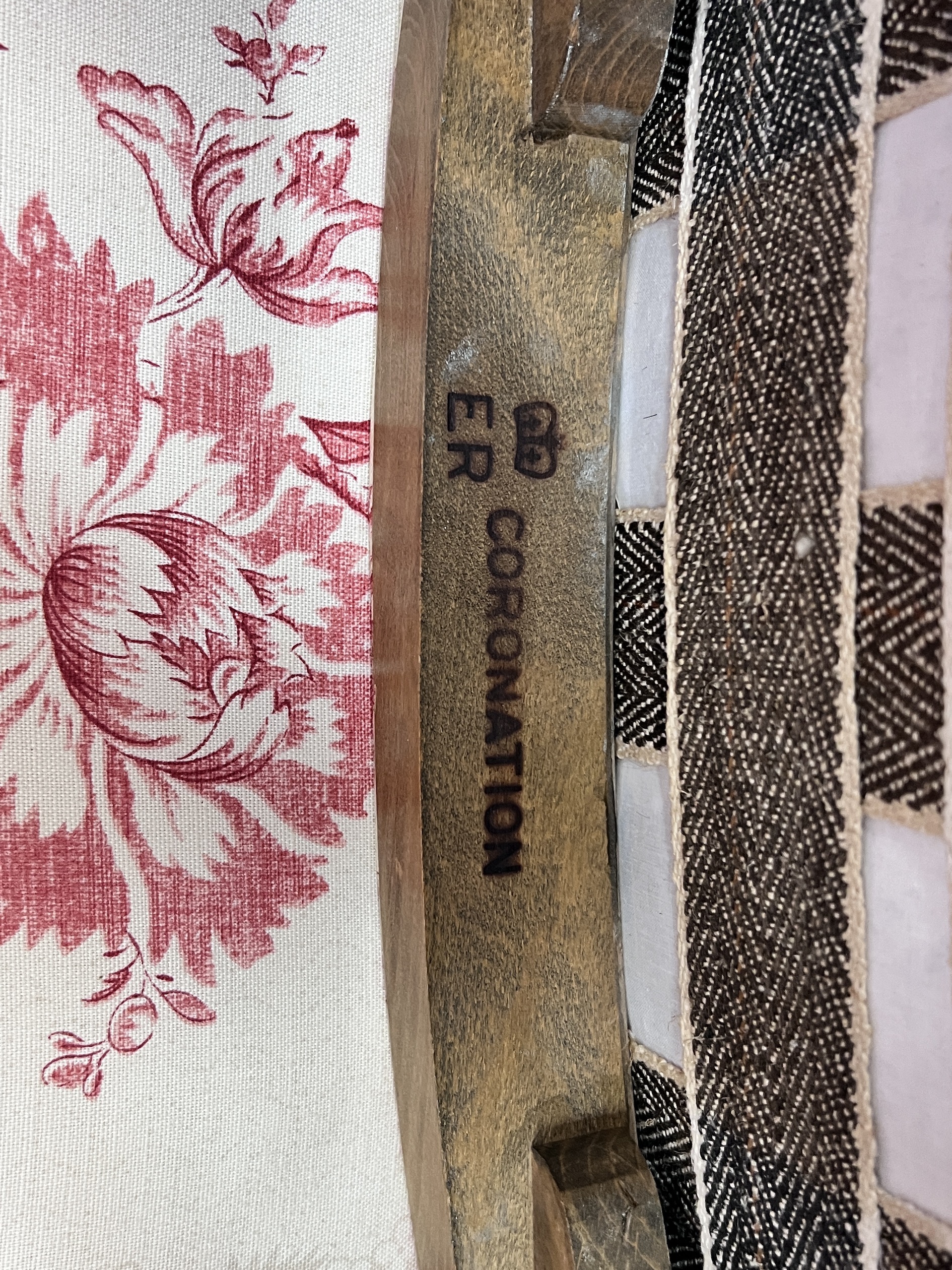 A reupholstered Coronation chair , the back applied with a George VI fabric remnant and an Elizabeth II Coronation stool